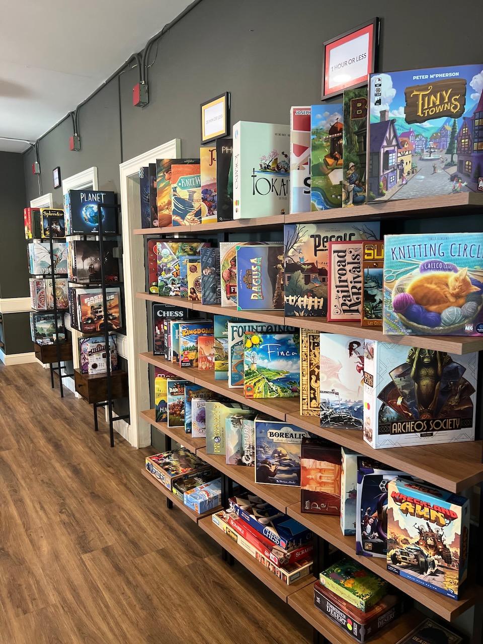 Shelves lined with board games along the café hallway