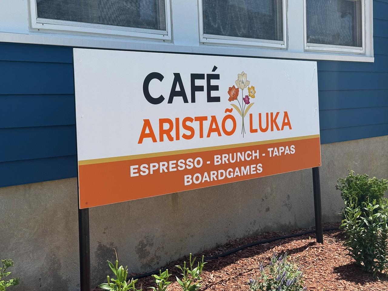 A close-up of the Café Aristaõ Luka sign